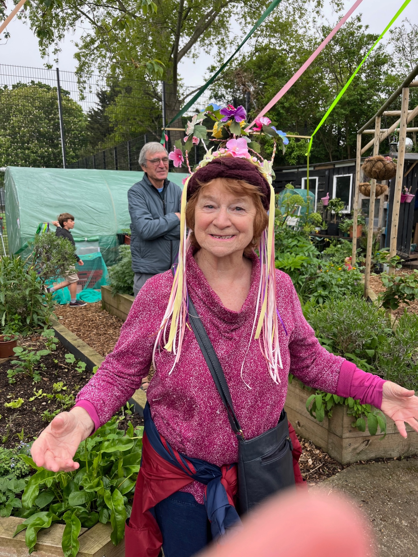 Green Queen Mandy Troughton wearing a flower crown with ribbons