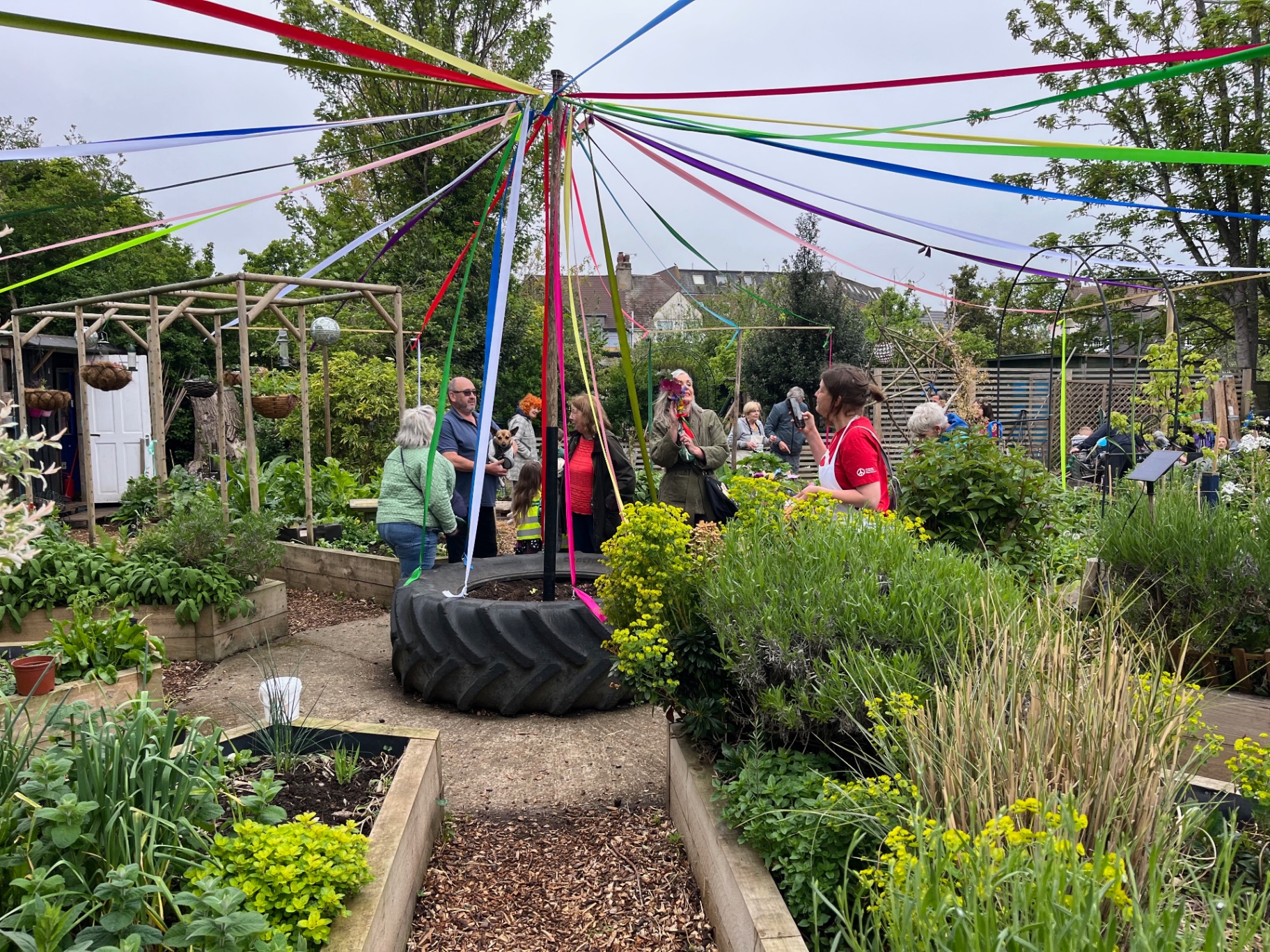 Community Kitchen Garden decorated with colourful maypole ribbons for May Day